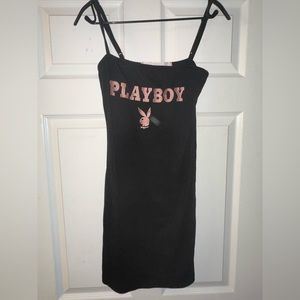 NWOT never worn playboy black dress. Pink embroidering, body con fit.